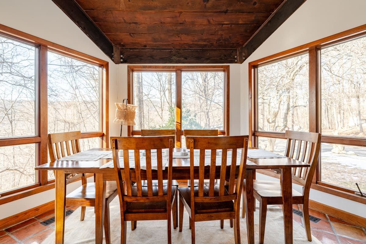 The dining table of a real Trustead home, looking out into the woods